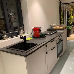 a kitchen with a sink and a counter top at Les Rives du vignoble in Ingersheim