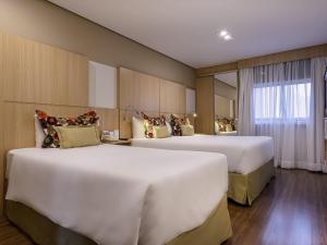 Postel nebo postele na pokoji v ubytování Mercure São Paulo Nações Unidas