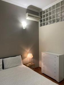 a bedroom with a bed and a lamp and a dresser at La Pieve di Luca in La Spezia