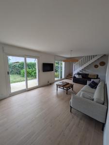 a large living room with a couch and a tv at La p'tite marquise in Roscoff