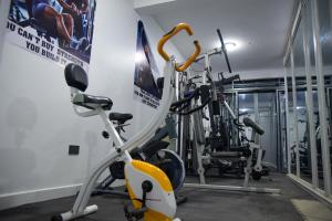 a gym with several exercise bikes in a room at Mileleishome in Buwate