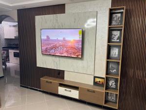 a television on a wall in a living room at Appart de Luxe à LAVERDA - à 400m de la plage in Dakhla