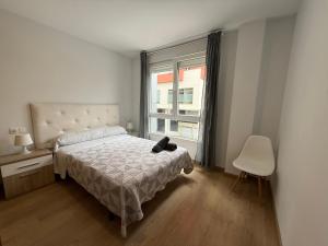 a bedroom with a bed and a window at SX50 Vut in Lugo