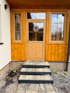 a front door of a house with stairs in front at Chata pod Jabloňou in Banská Štiavnica +32 photos