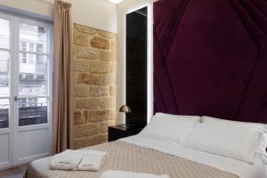 Ένα ή περισσότερα κρεβάτια σε δωμάτιο στο Isidoro Luxury Suites