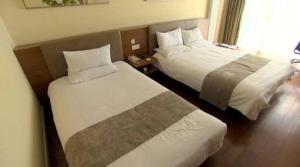 a hotel room with two beds in a room at Pest Downtown Inn in Budapest +4 photos