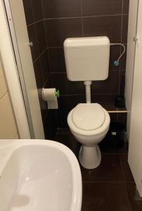 a small bathroom with a toilet and a sink at Pest Downtown Inn in Budapest