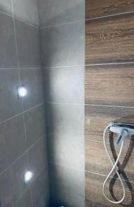 a shower with two lights on a tiled wall at Pest Downtown Inn in Budapest