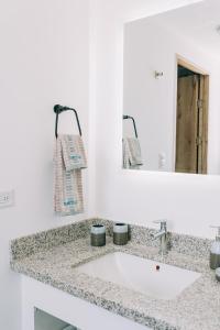 a bathroom counter with a sink and a mirror at NEW Cozy&Modern Apt 30min from SurfCity in Hacienda Plan de La Laguna +61 photos