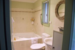 a bathroom with a tub and a toilet and a sink at Copeland House in Copeland +56 photos