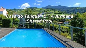 a shaded pool in a villa with a view at A Arribana in Nordestinho
