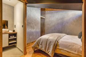 a bedroom with a bed with a large wall at La Ferme à Roland ski in - ski out - Happy Rentals in Chamonix-Mont-Blanc