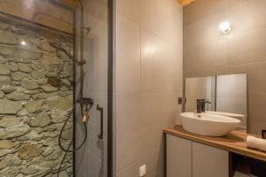 a bathroom with a sink and a shower at La Ferme à Roland Cozy Mountain Style 2BR for 6 Ski In/Ski out - Happy Rentals in Chamonix +21 photos