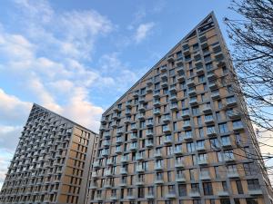 two tall buildings standing next to each other at Devana Premium Apartments by CHORS in Nivy