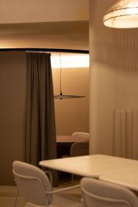 a table and chairs in a room with a light at OPERA Boutique Hotel & Restaurant & Bar in Rijeka +77 photos