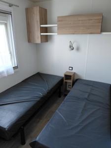 a bedroom with two beds and a window at Val'B ocean-bord de plage in Sarzeau