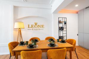 a dining room with a wooden table and chairs at Leone Stays - Golden Castle Loft in Thun
