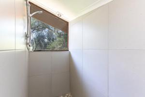 a bathroom with a shower with a window at Watermill Studios in Gordonʼs Bay +34 photos