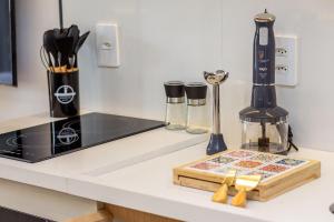 a kitchen counter with a cutting board and a blender at Studios Sampa - Vila Buarque - Santa Casa in São Paulo +105 photos
