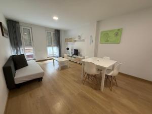 a living room with a table and a couch at SF40 Vut in Lugo +31 photos