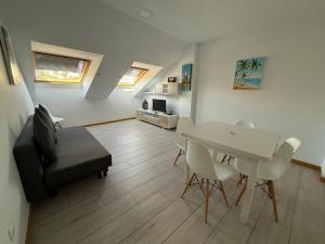 a living room with a white table and chairs at SF40 Vut in Lugo