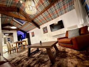 a living room with a couch and a table at The Coach House by The Hive WA1 in Warrington