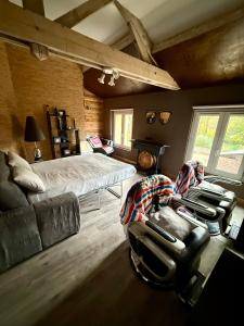 a bedroom with a bed and a couch and a chair at La Laiterie 