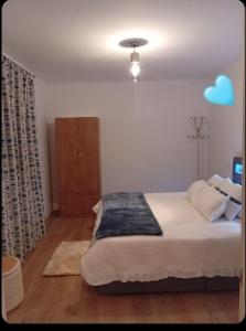 a bedroom with a bed with a blue cloud on the wall at O Caminho Azul in Olivenza +17 photos