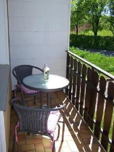 a table and two chairs on a porch with a table at Naturblick in Berndorf