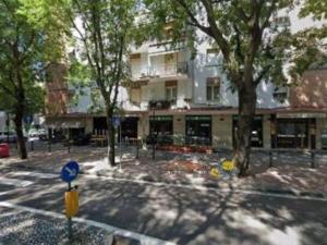 a building on a street with trees in front of it at Parma soggiorni brevi in Parma