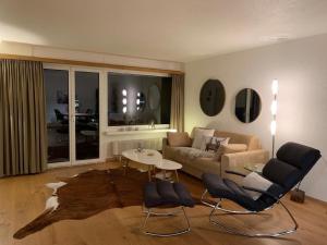 a living room with a couch and a table and chairs at Chäserruggblick in Unterwasser