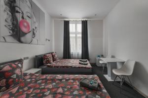 a hotel room with a bed and a desk at 70s Guest room in Kraków
