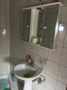 a bathroom with a sink and a mirror at Bujtina (Pension) Oltas in Prizren