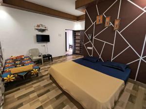 a bedroom with a king sized bed and a tv at Sea view holiday resort in Borlai