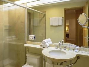 a bathroom with a toilet and a sink and a shower at Mercure Sao Paulo Jardins in Sao Paulo +107 photos