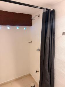 a bathroom with a shower curtain in a room at Hotel Chuburna in Chuburná
