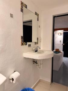 a bathroom with a sink and a mirror and a toilet at Hotel Chuburna in Chuburná +15 photos