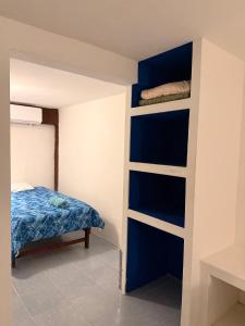 a bedroom with a blue and white bunk bed at Hotel Chuburna in Chuburná