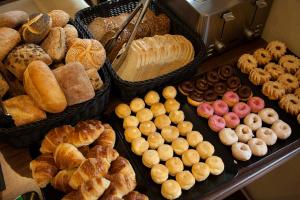 a display case with various types of bread and pastries at Quentin Design Hotel Berlin in Berlin