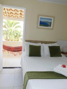 En eller flere senge i et værelse på Pousada Luzes de Geribá