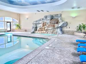 a pool in a house with a rock wall at Cozy Zermatt Swiss King Villa with Kitchen Near Park City & Deer Valley Ski Resorts - 1089 in Mound City
