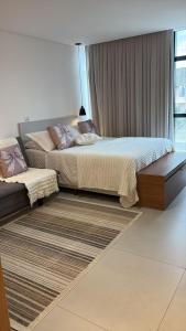 a bedroom with two beds and a window at Apartamento Milla 1 in Pomerode