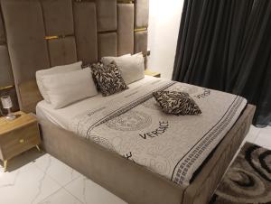 a bed with two pillows on it in a bedroom at Happy place in Port Harcourt