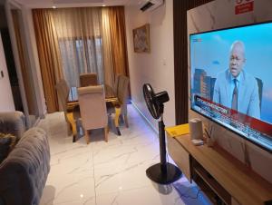 a living room with a large flat screen tv at Happy place in Port Harcourt