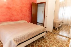 a bedroom with a bed and a mirror at DA BETTY - Mondo Antico experience in Cerveteri