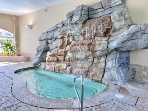 a swimming pool with a waterfall in a home at Alpine Double Queen Suite Near Park City & Deer Valley Ski Resorts - 134 in Mound City +11 photos