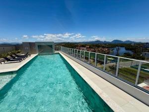 a swimming pool on the balcony of a building at Peracanga Bacutia Guarapari LS05 in Guarapari