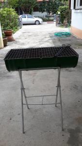 a barbecue grill sitting in a parking lot at Mae Rampung Beach House Pool Villa in Rayong
