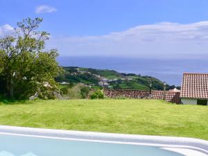 a view from the roof of a house with a green field at Casabelavista Iii in Fajã do Araújo