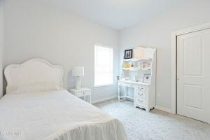 a white bedroom with a bed and a white shelf at Confortable House in West Side in Canutillo